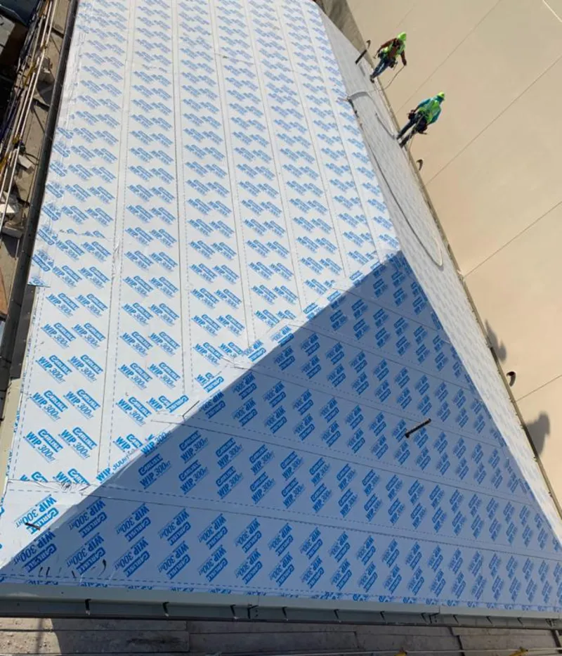 Professional roofers installing underlayment on a metal roof in South Hanover